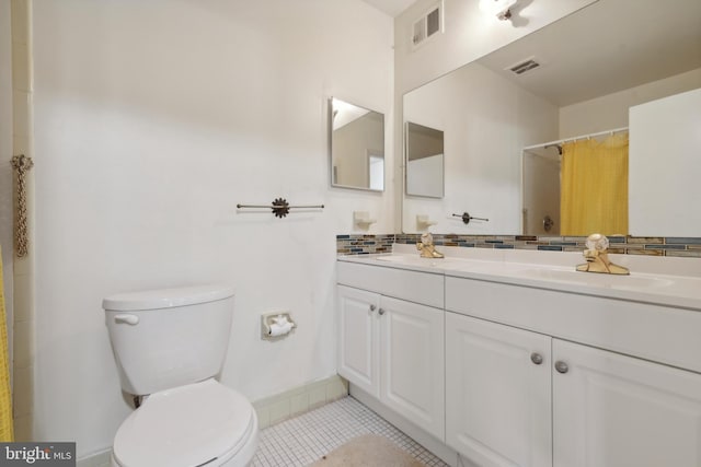 bathroom with a shower with curtain, tile patterned flooring, vanity, and toilet