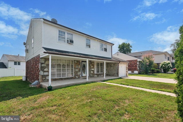 front facade featuring cooling unit, covered porch, and a front yard