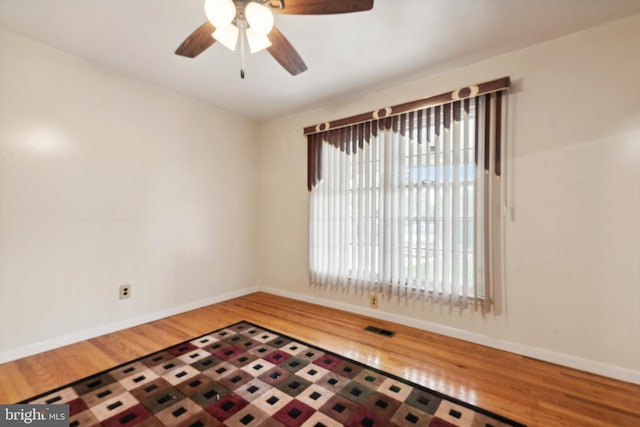 unfurnished room with ceiling fan and hardwood / wood-style flooring