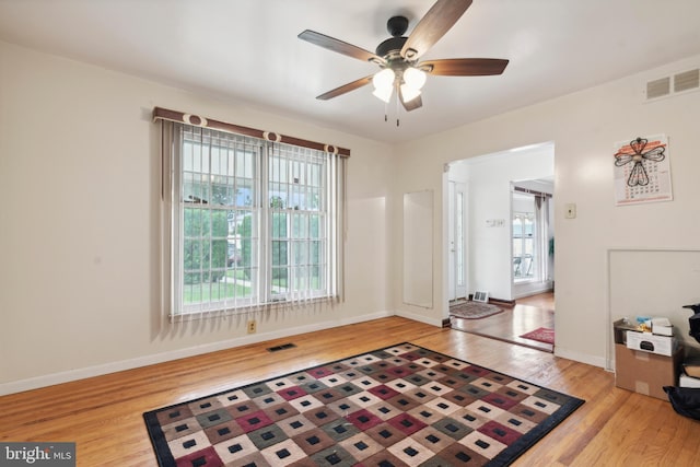 interior space featuring ceiling fan, a wealth of natural light, and light hardwood / wood-style flooring