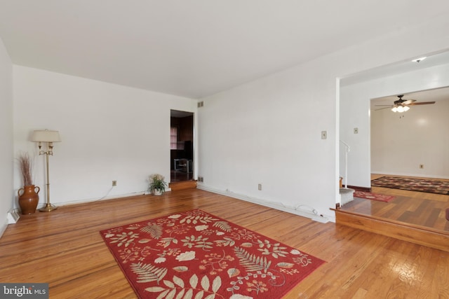 living room with wood-type flooring and ceiling fan