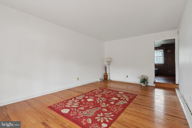 unfurnished room with wood-type flooring