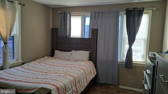 bedroom with dark tile patterned flooring