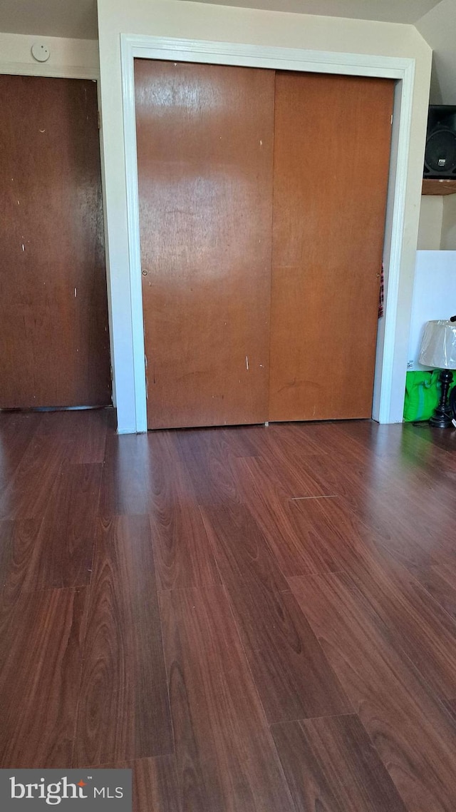 unfurnished room with dark hardwood / wood-style floors