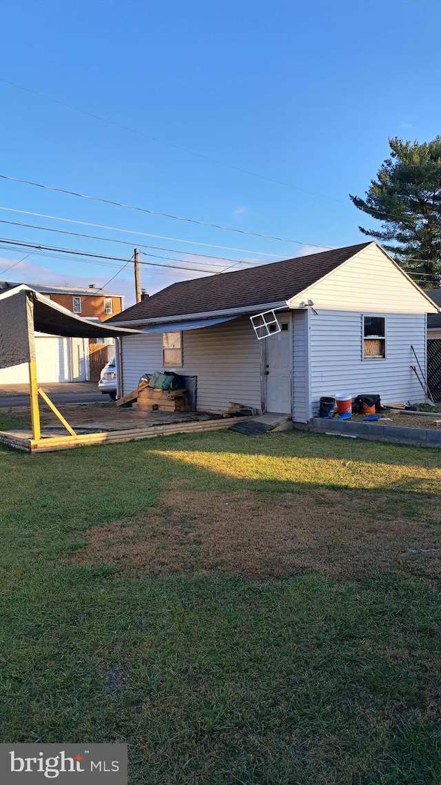 rear view of property with a lawn