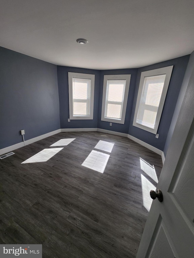 empty room featuring dark wood-type flooring