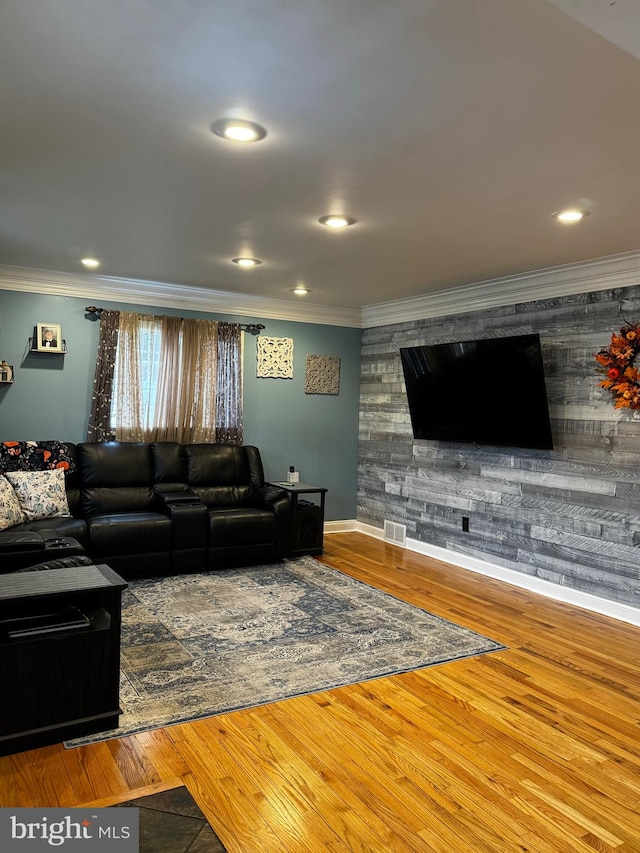 living room with hardwood / wood-style floors and ornamental molding