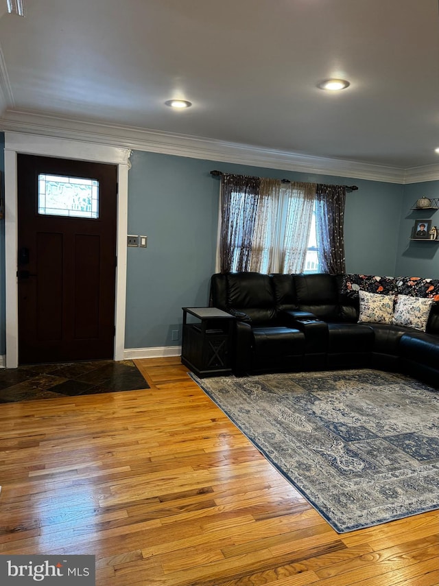 living room featuring crown molding and hardwood / wood-style flooring