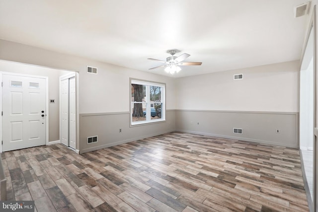 empty room with hardwood / wood-style flooring and ceiling fan