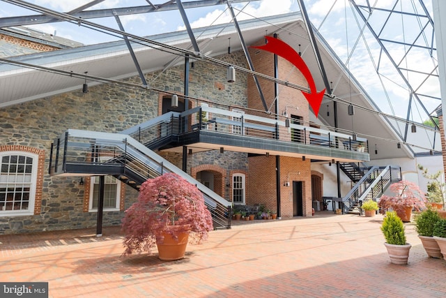 rear view of property featuring a balcony