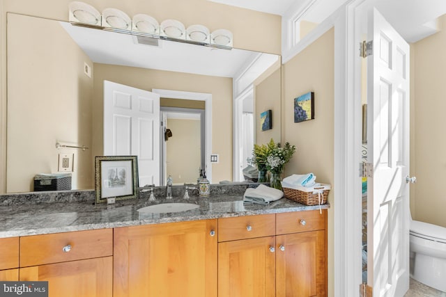 bathroom with vanity and toilet