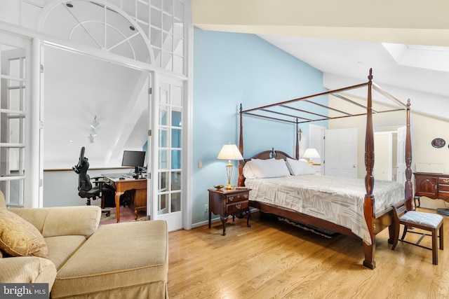 bedroom with french doors and light hardwood / wood-style floors