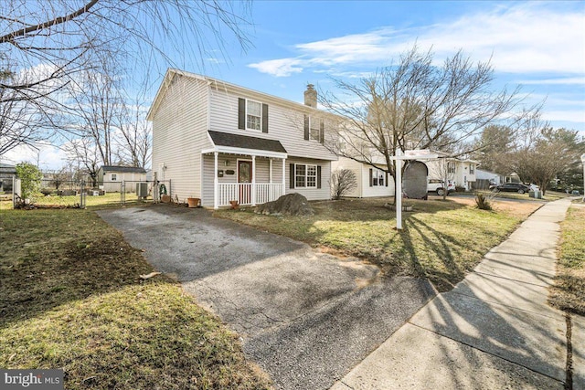 front of property featuring covered porch and a front lawn