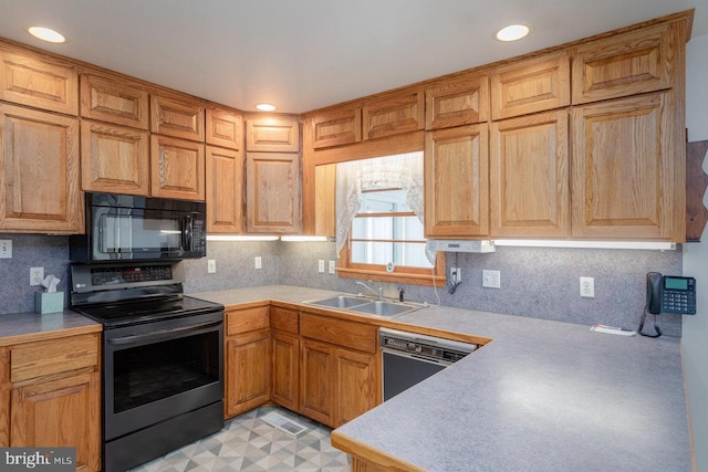 kitchen with decorative backsplash, sink, and black appliances