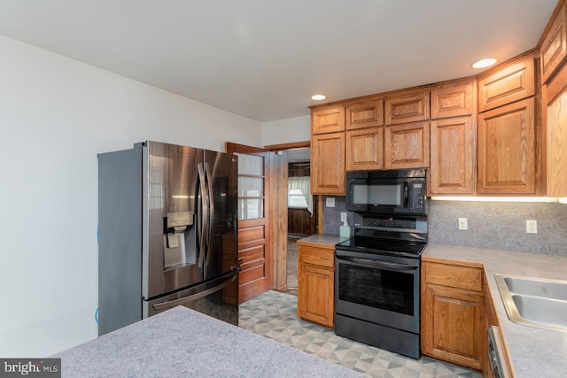 kitchen featuring sink, stainless steel appliances, and tasteful backsplash