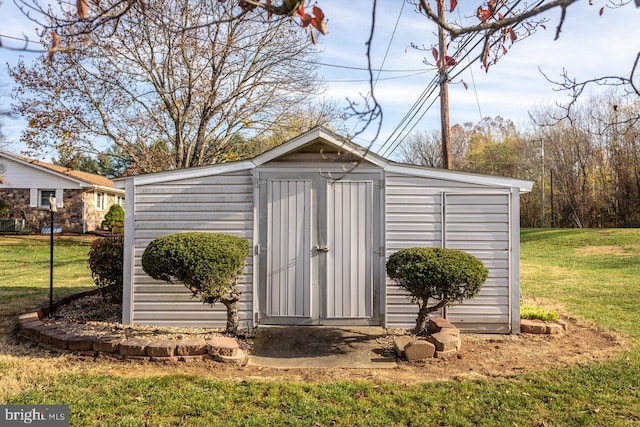 view of outdoor structure featuring a lawn