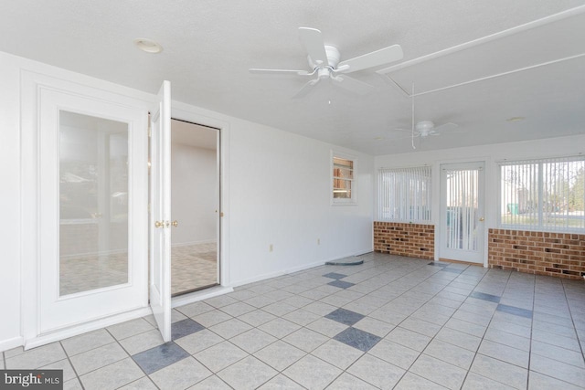 spare room with light tile patterned floors and brick wall