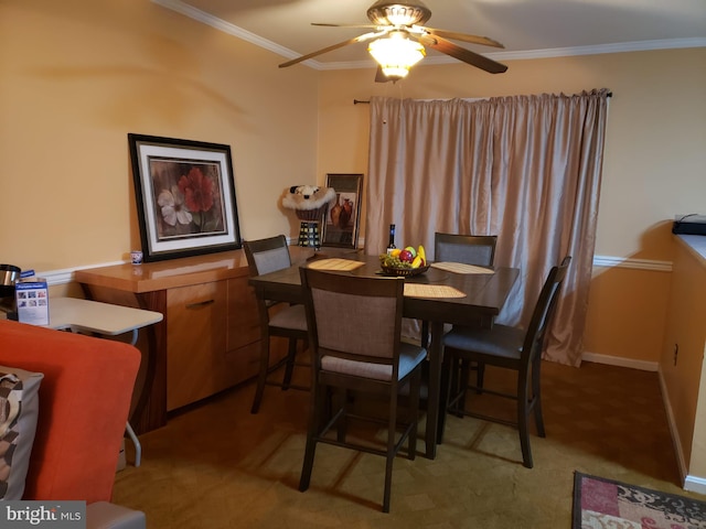 dining area with crown molding and ceiling fan