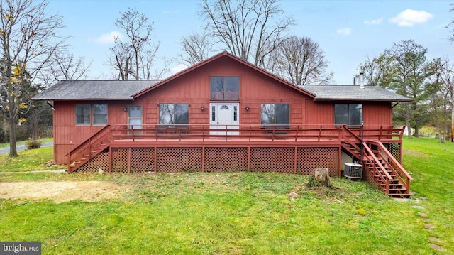 back of property featuring a lawn, cooling unit, and a wooden deck