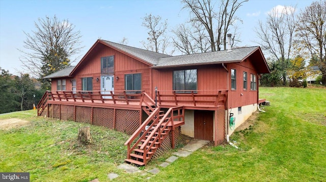 rear view of house featuring a yard and a deck