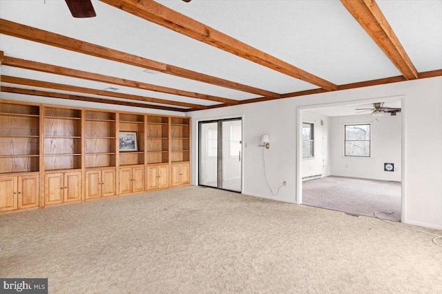 unfurnished living room with beamed ceiling, ceiling fan, light carpet, and a baseboard heating unit