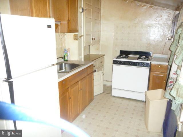 kitchen with white appliances and sink