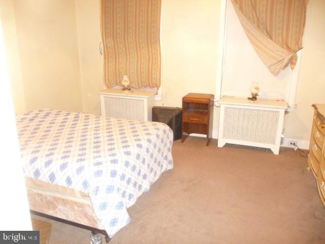 carpeted bedroom featuring radiator heating unit