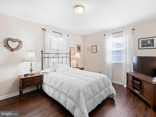 bedroom featuring multiple windows and dark wood-type flooring