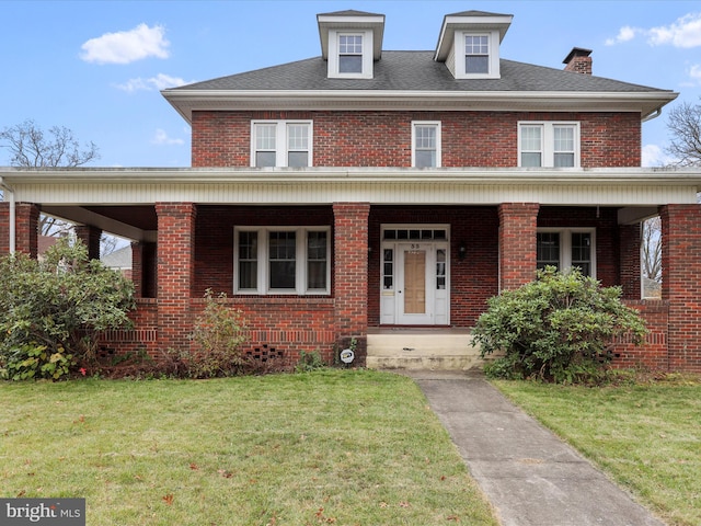 view of front facade with covered porch and a front yard