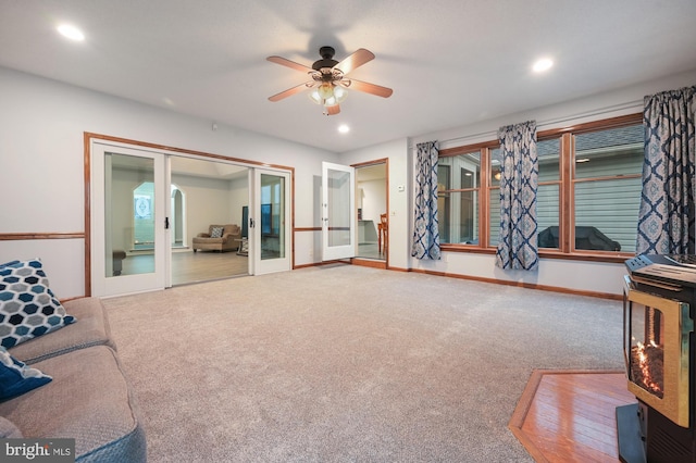 living room featuring carpet flooring, ceiling fan, and french doors