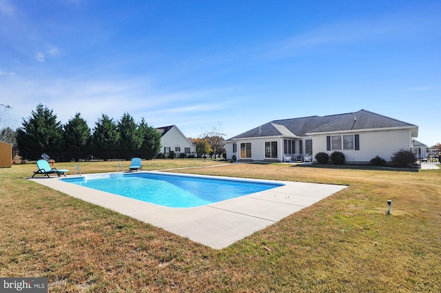 view of pool featuring a lawn and a patio