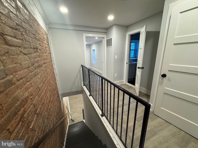 stairs featuring wood-type flooring