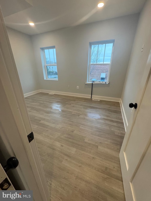 unfurnished room with light wood-type flooring