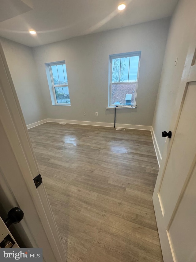 unfurnished room with light hardwood / wood-style flooring