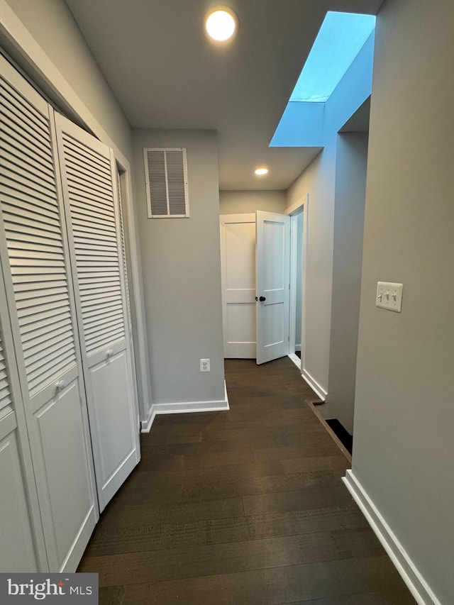 corridor with dark hardwood / wood-style floors