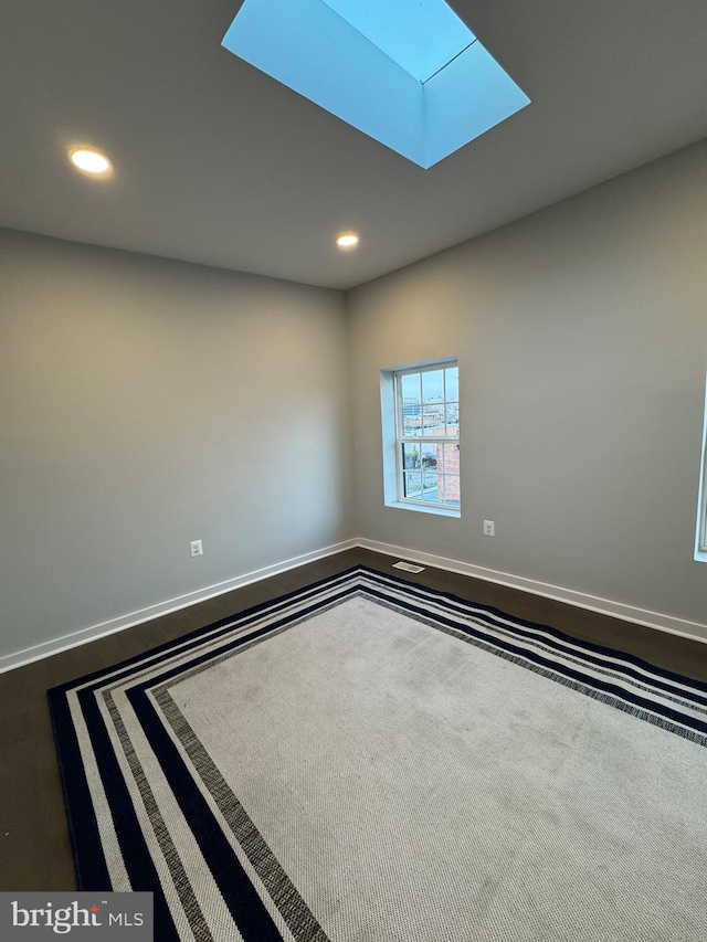 spare room with a skylight