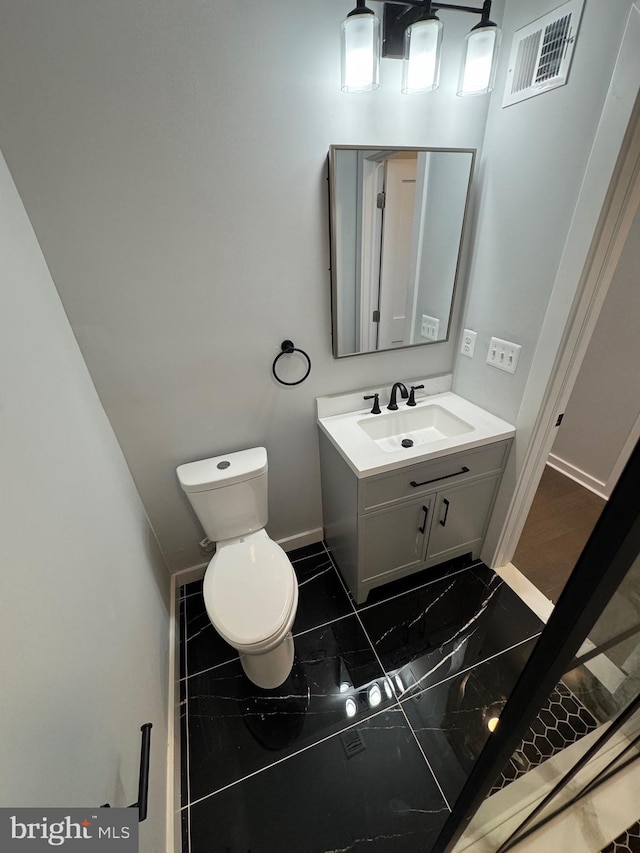 bathroom with vanity and toilet