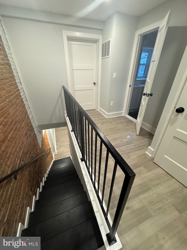 staircase featuring hardwood / wood-style floors