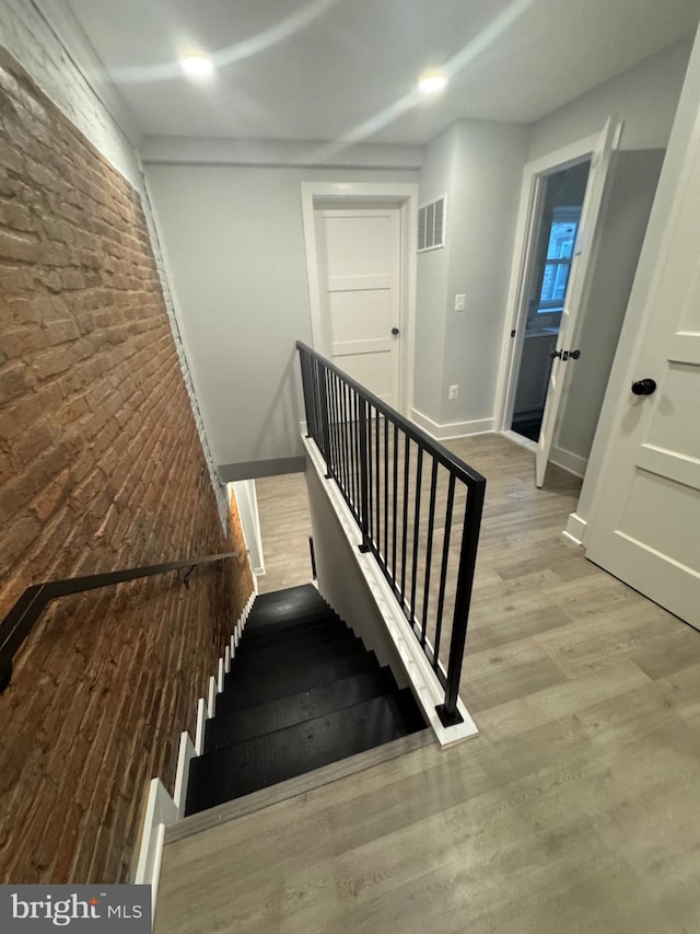 stairs featuring hardwood / wood-style flooring