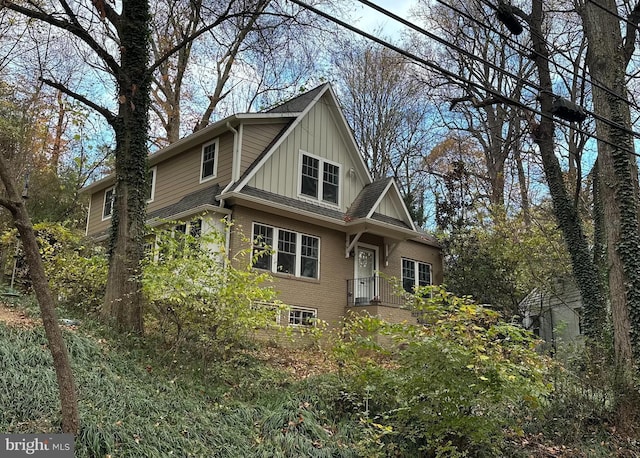 view of front facade featuring board and batten siding and brick siding