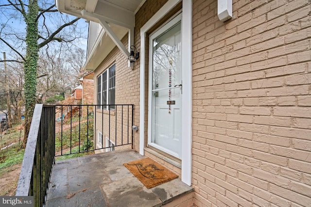 property entrance featuring brick siding