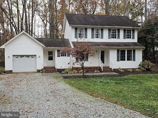 front facade with a garage and a front lawn