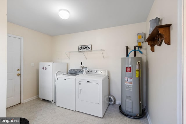 washroom featuring water heater, washer and clothes dryer, and light tile patterned floors