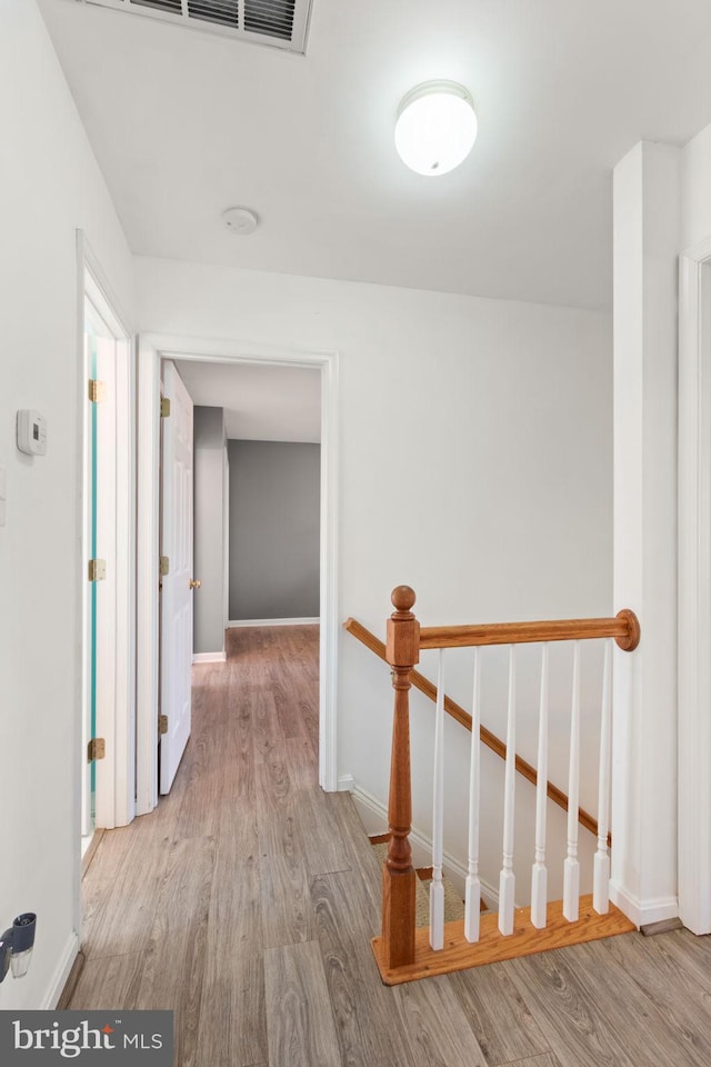 hallway with light hardwood / wood-style flooring