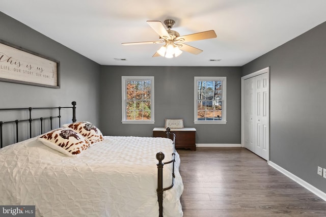 bedroom featuring dark hardwood / wood-style flooring, a closet, and ceiling fan