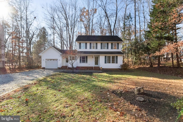 view of front of house with a front yard and a garage