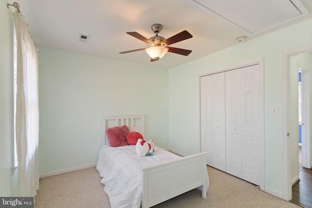 bedroom with multiple windows, light colored carpet, and ceiling fan