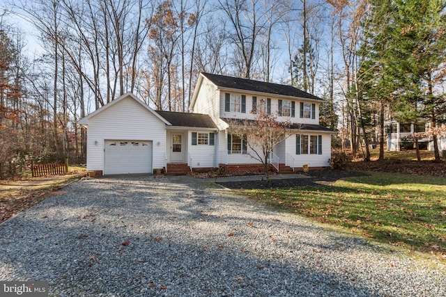 view of front of property with a garage and a front lawn