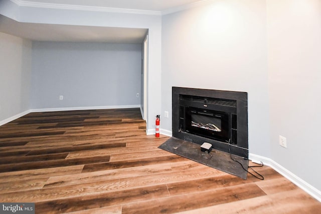 interior details featuring hardwood / wood-style flooring and ornamental molding