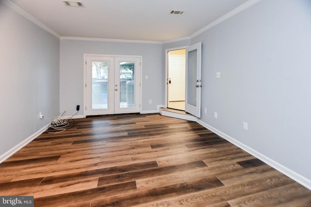 spare room with dark hardwood / wood-style flooring, crown molding, and french doors